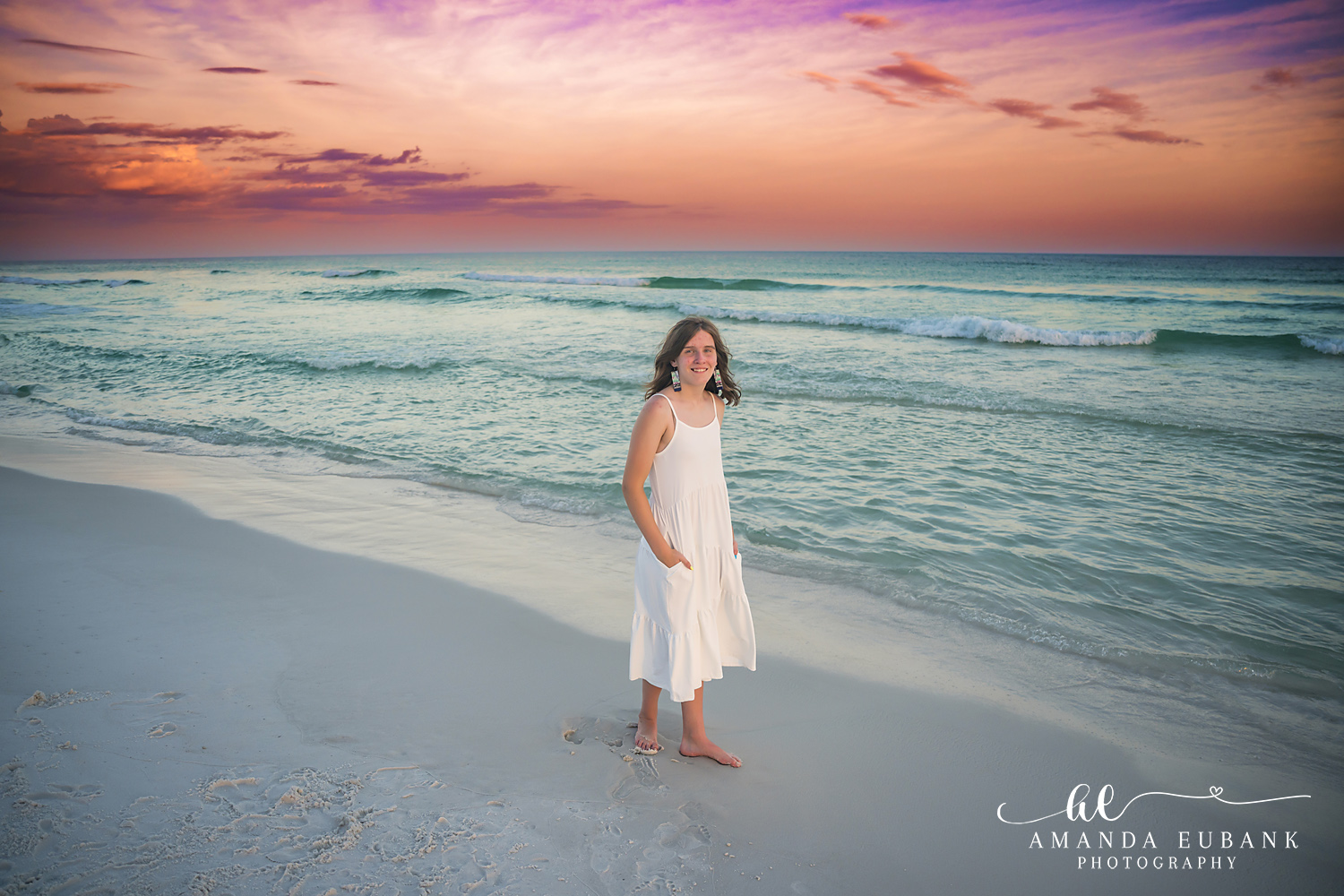 Destin Family Photographer – Solo Portrait at the Water’s Edge Woman standing alone at the water's edge in a white dress in Destin, Florida