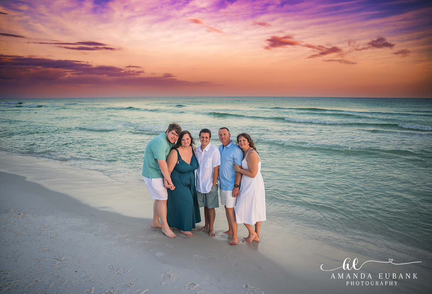 Destin Family Photographer – Family Portrait at Golden Hour Family group posing together on the beach at golden hour in Destin, Florida