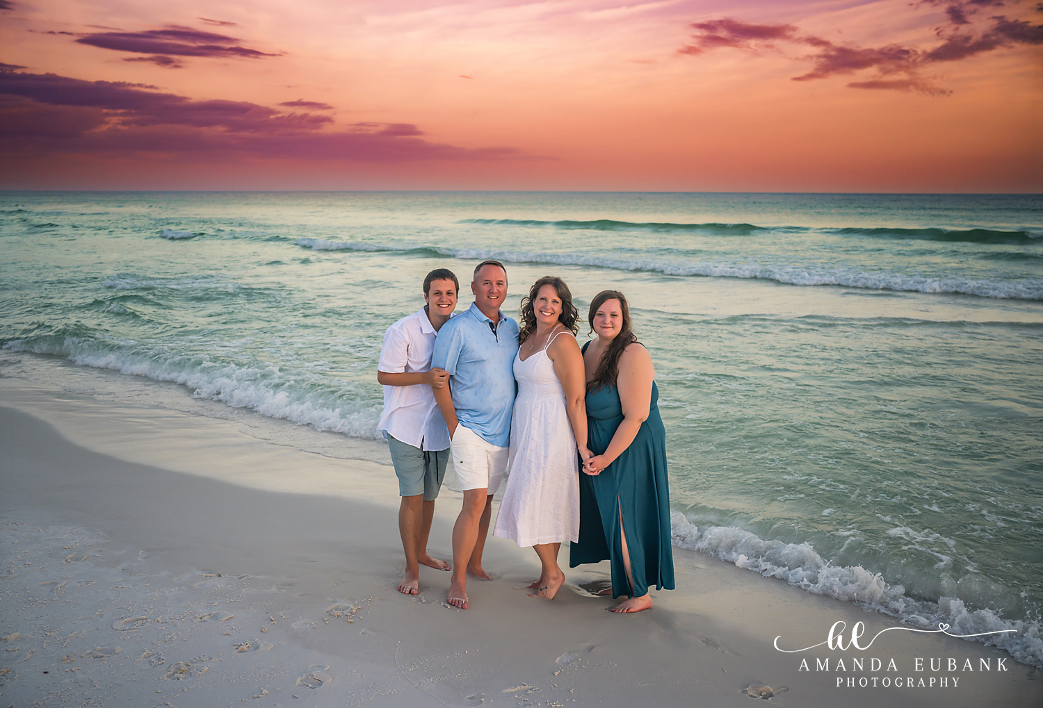 Destin Family Photographer – Family Gathered on the Beach Family of four gathered together on the beach in Destin, Florida