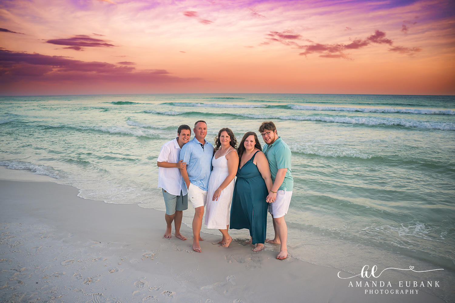 Destin Family Photographer – Family of Four on the Sand Family of four standing together on the beach in Destin, Florida