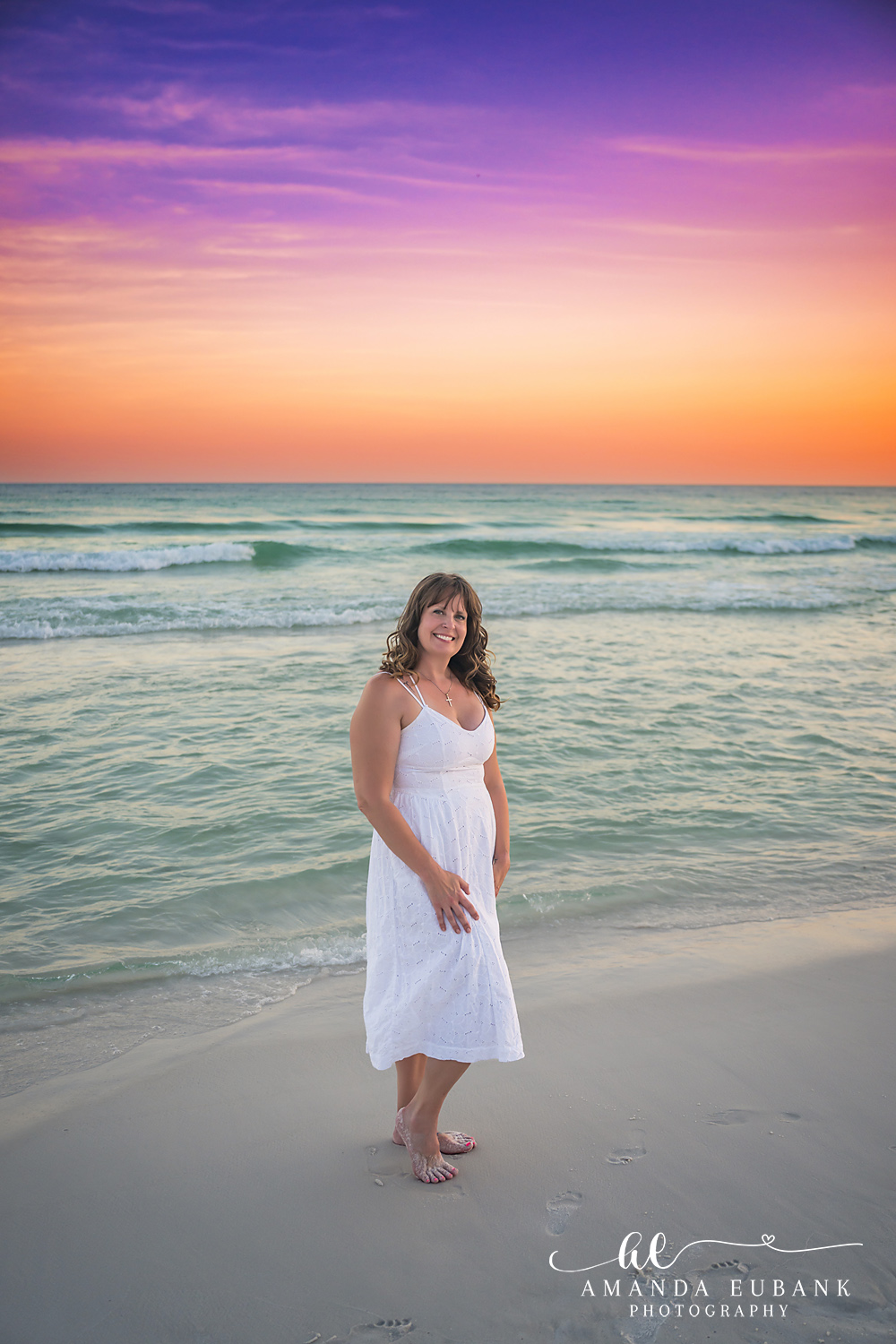 Destin Family Photographer – Standing on the Shoreline in White Woman in a white dress standing on the shoreline in Destin, Florida