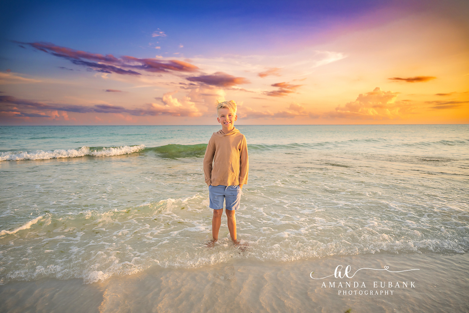Destin Beach Family Session – Boy in the Shallow Surf Young boy standing alone in the shallow surf at sunset during a Destin beach family photography session