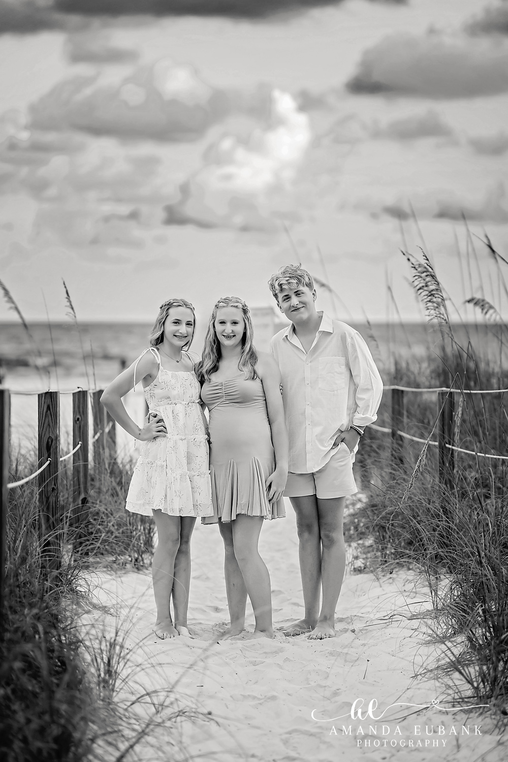 Black and White Destin Family Beach Portrait on the Dune Crossover Black and white portrait of three at the Destin dune line during a sunset beach session