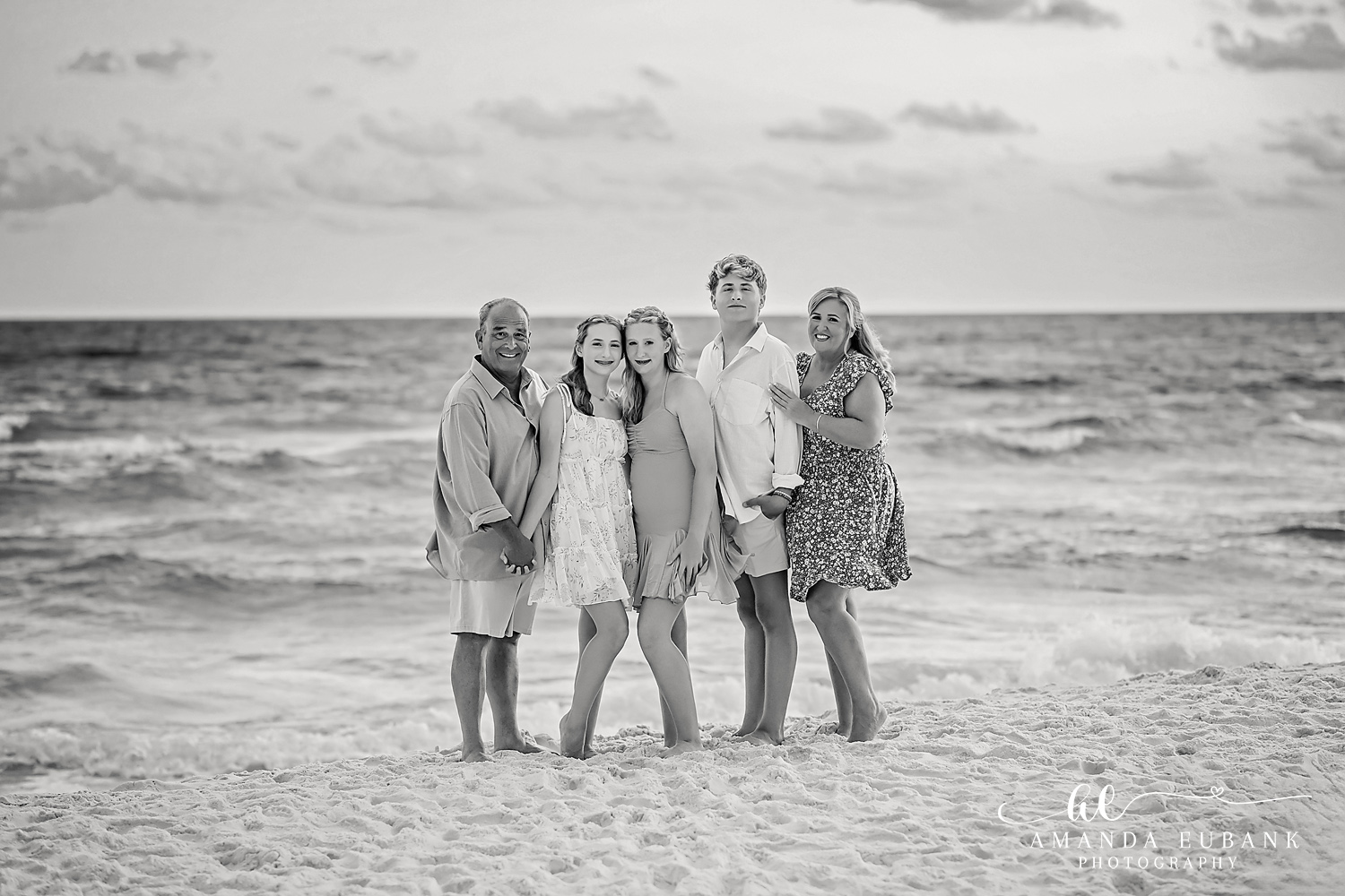 Black and White Extended Family Photo on the Destin Shoreline Black and white family of five at the Destin waterline during a sunset beach session