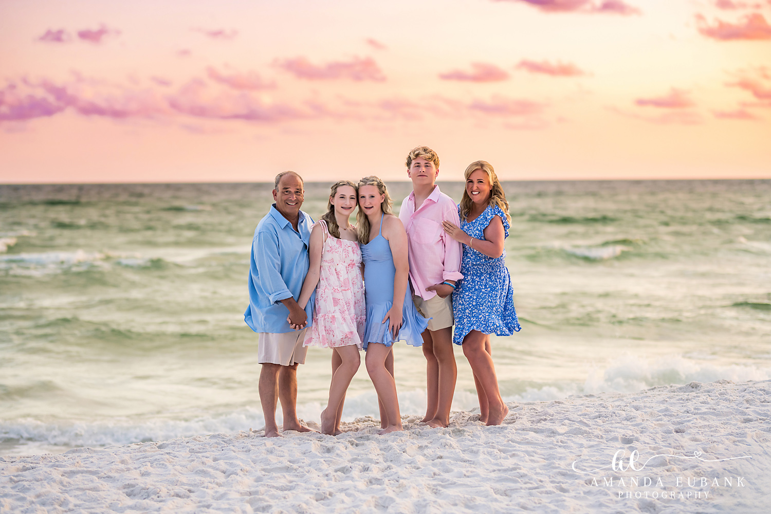 Destin Beach Photographer – Family of Five at the Water’s Edge Destin family photographer portrait of five on the shoreline under a pastel sunset sky