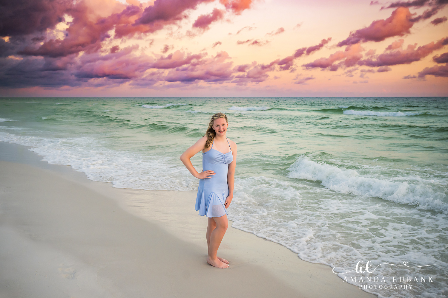 Destin Beach Photographer – Teen Portrait in the Shallow Surf Girl in a periwinkle dress walking the Destin shoreline as the sunset light turns gold