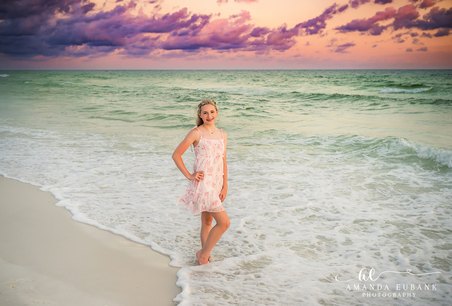 Destin Beach Photos – Girl in a Pink Dress in the Surf Girl in a pink floral dress standing ankle deep in the Gulf during a Destin sunset session