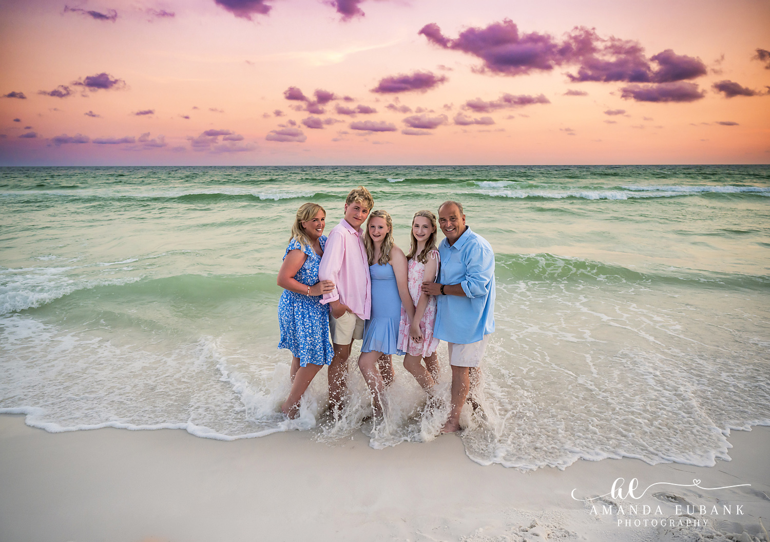 Family of five barefoot in the Gulf shallows during a Destin sunset family session