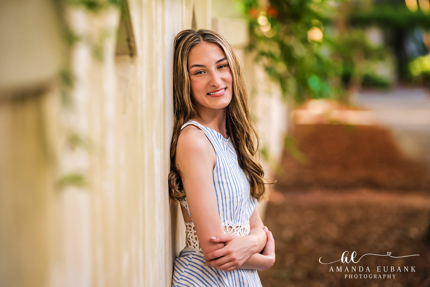 Rosemary Beach Senior Photographer – Light Blue Portrait in the Garden Senior girl in a light blue dress standing in a garden setting in Rosemary Beach, Florida