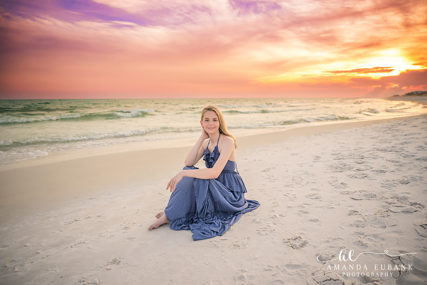 Rosemary Beach Senior Photographer – Navy Dress by the Water’s Edge Senior girl in a navy dress sitting on the sand near the water's edge in Rosemary Beach, Florida