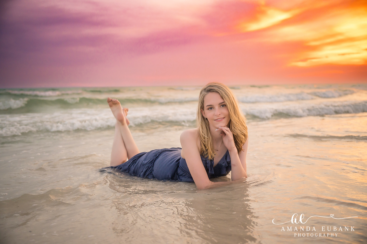 Rosemary Beach Senior Photographer – Resting in the Shallow Surf Senior girl lying in shallow ocean water in a navy dress at sunset in Rosemary Beach, Florida