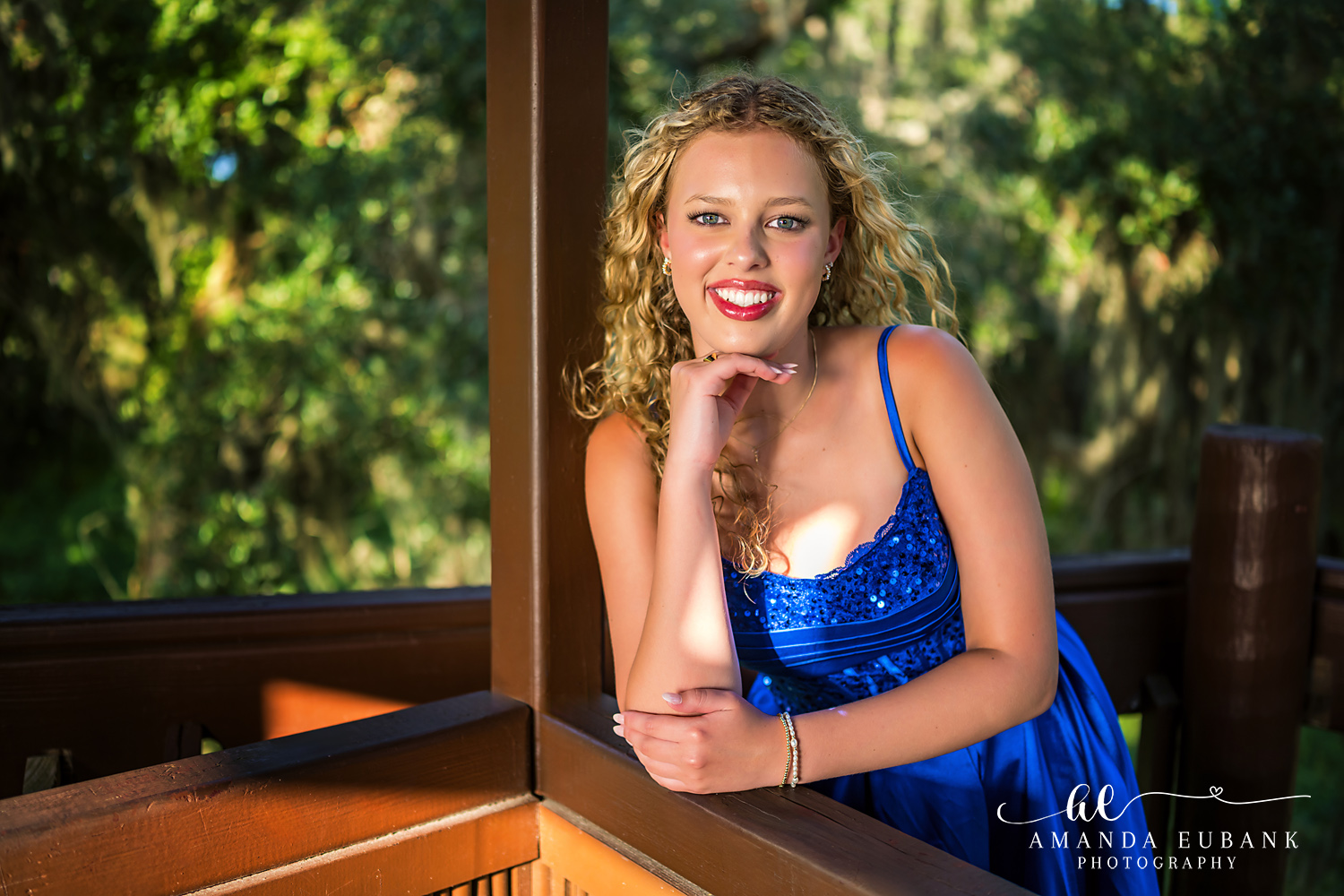 Sandestin Senior Photographer – Close-Up Portrait on the Steps Close-up portrait of a senior in a blue dress sitting on wooden steps in Sandestin, Florida