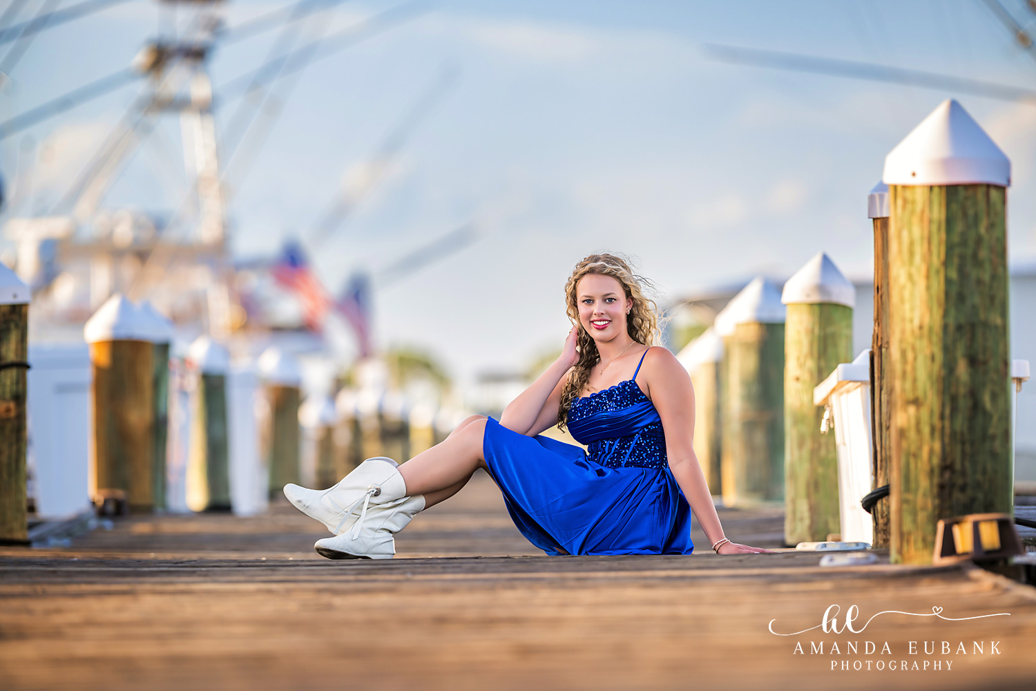 Sandestin Senior Photographer – Portrait Among the Beach Cabanas High school senior standing on a boardwalk near colorful beach cabanas in Sandestin, Florida