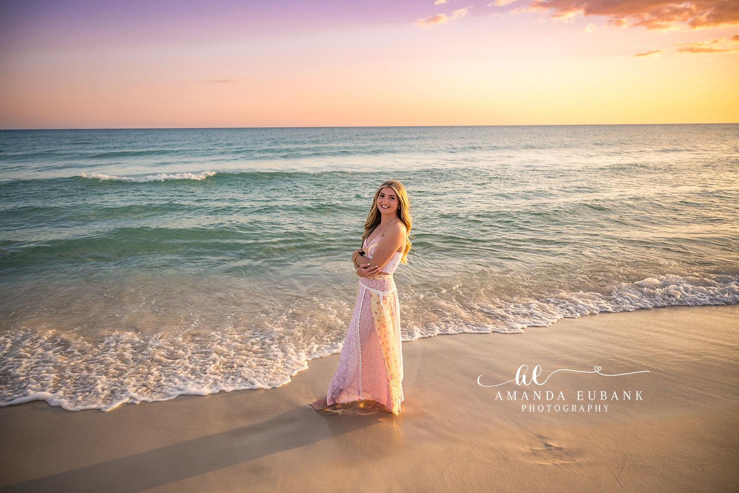 Santa Rosa Beach Senior Session – Pastel Sunset on the Gulf Wide beach portrait of a high school senior in a blush gown at the water's edge under a pastel sunset in Santa Rosa Beach