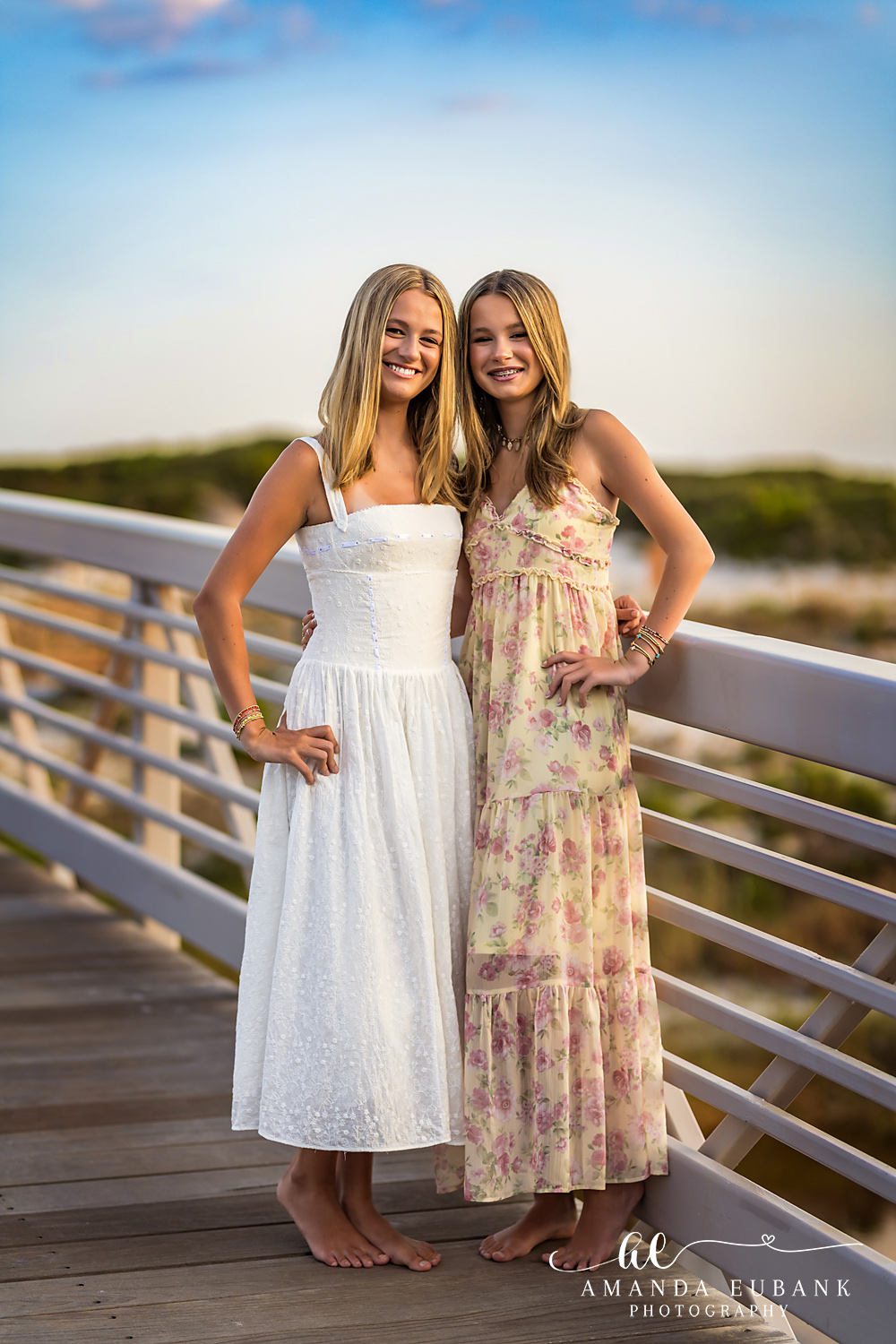 WaterSound Beach Sisters Portrait on the Bridge Two sisters smiling together on a bridge boardwalk near WaterSound Beach