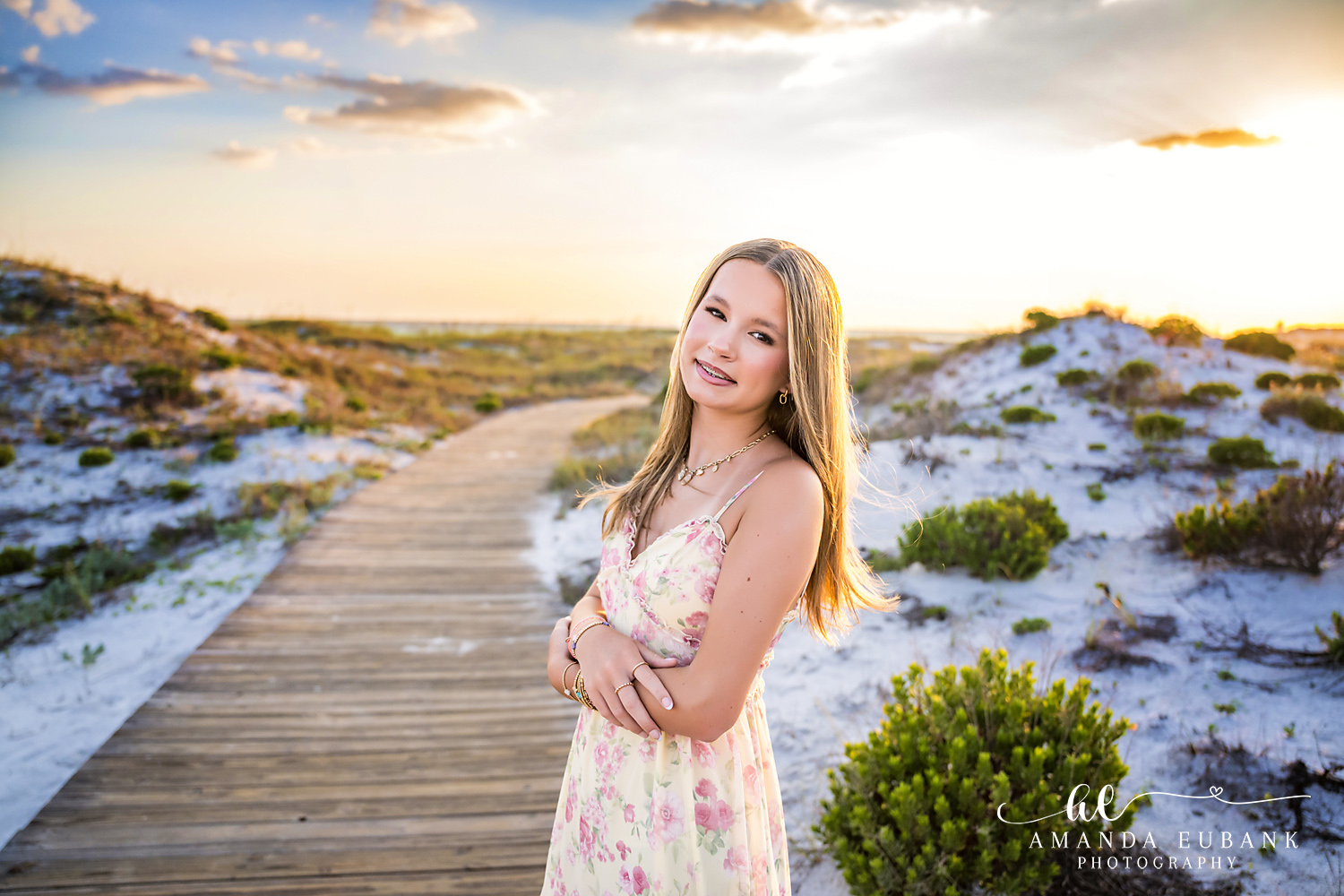 WaterSound Beach Sunset Portrait – Teen in Floral Dress Teen girl in a floral dress smiling on the boardwalk at WaterSound Beach during sunset