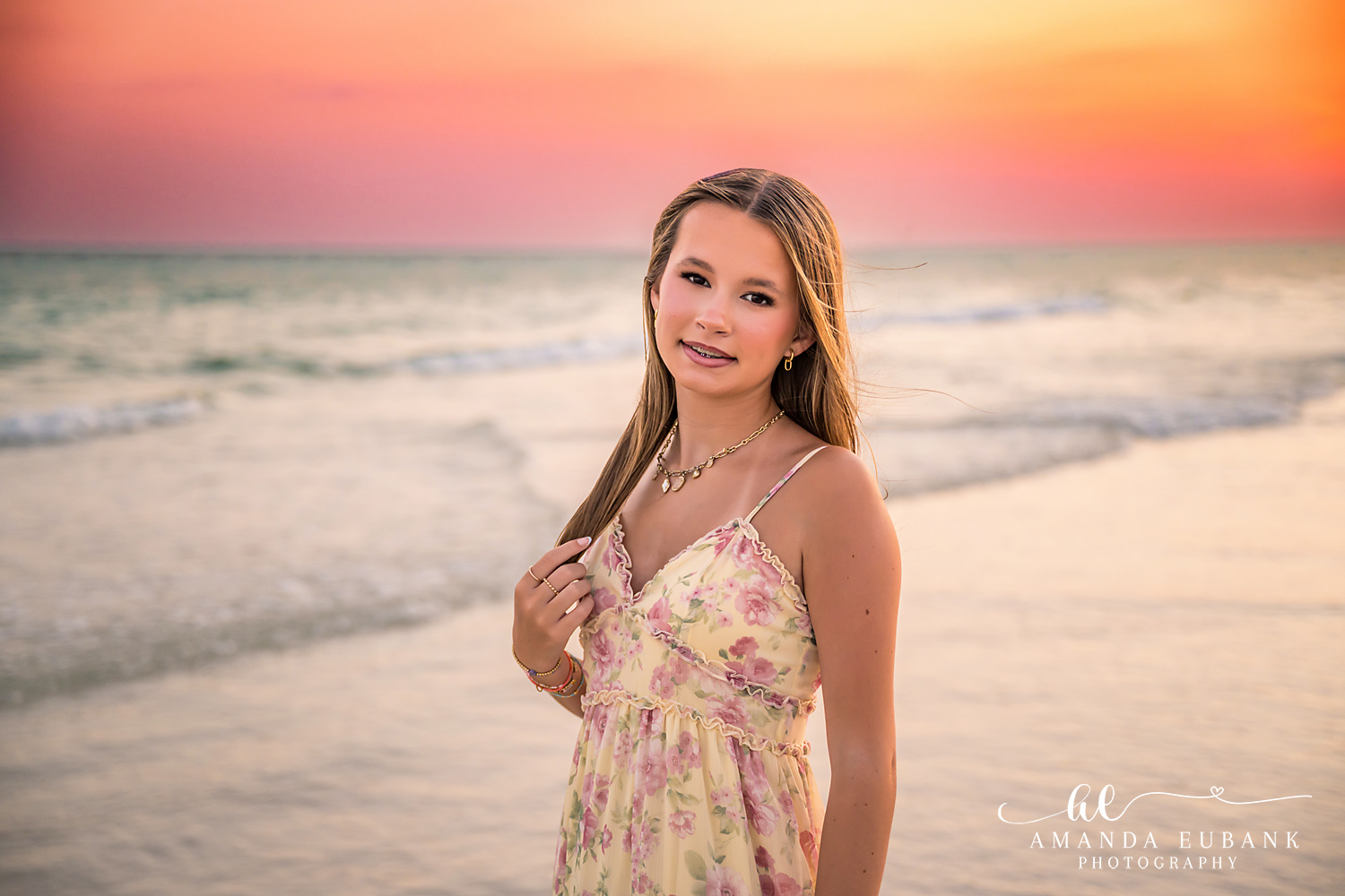 WaterSound Beach Sunset Portrait – Girl in Floral Dress Teen girl in a floral sundress smiling on the beach at sunset during a WaterSound family photography session