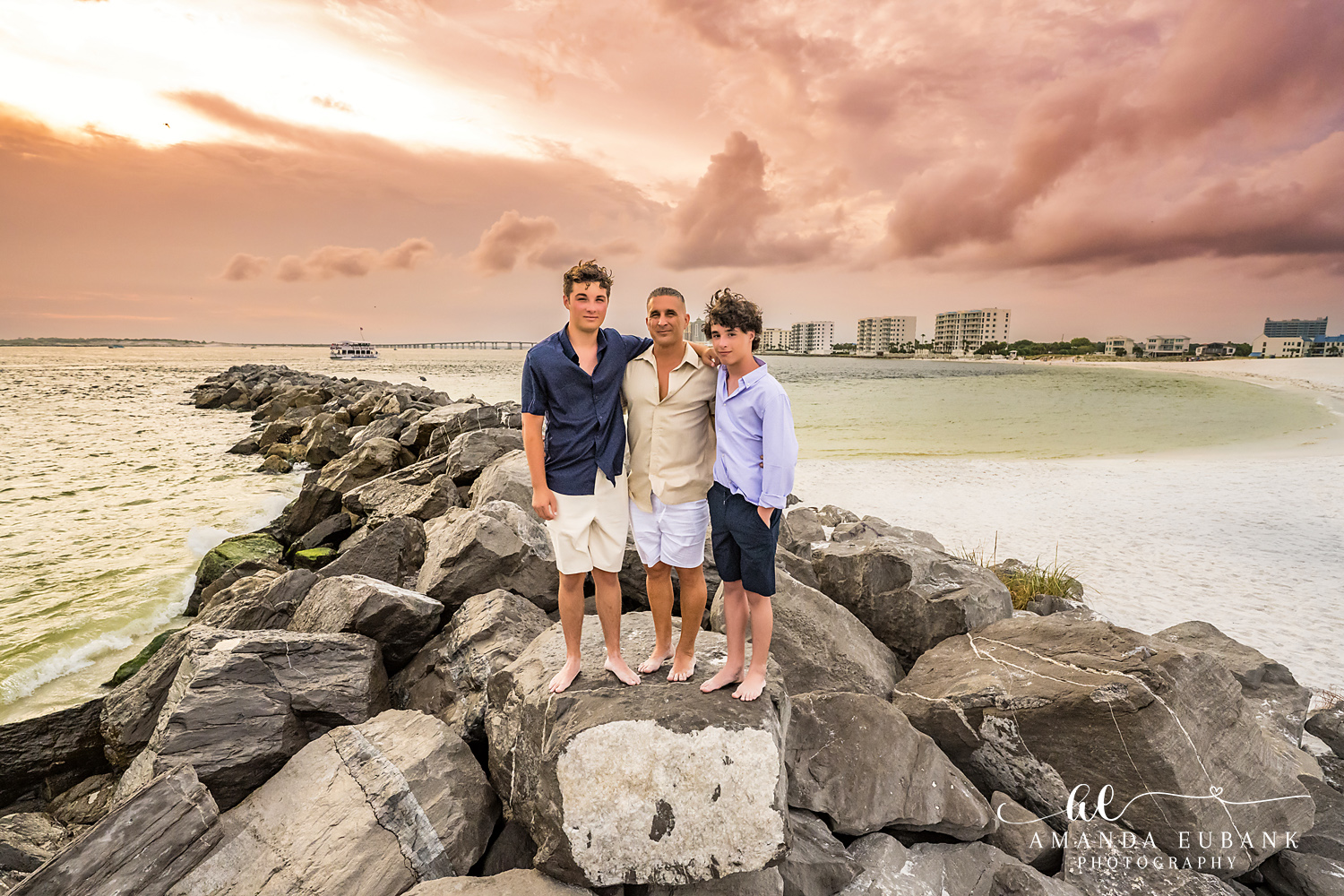 Destin Jetties Family Photos | Three boys standing together Three boys standing together on the rocks at the Destin Jetties in Destin, Florida at sunset, photographed by Destin family photographer Amanda Eubank