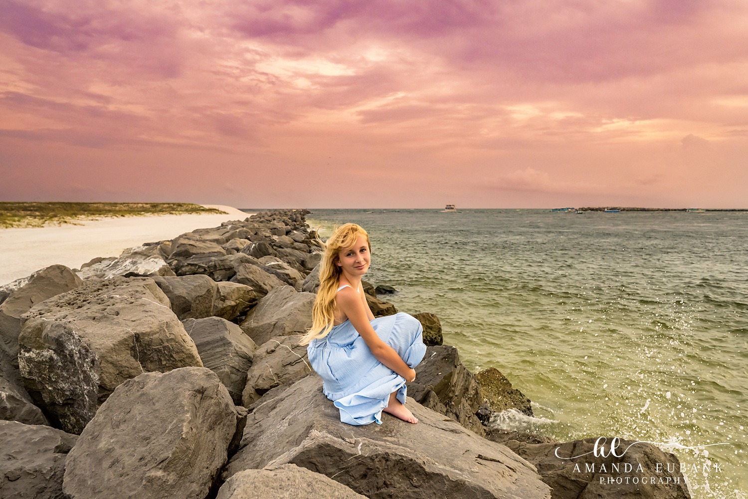 Destin Jetties Family Photos | Teen girl in a blue dress A teen girl in a blue dress on the rocks at the Destin Jetties in Destin, Florida at sunset, photographed by Destin family photographer Amanda Eubank