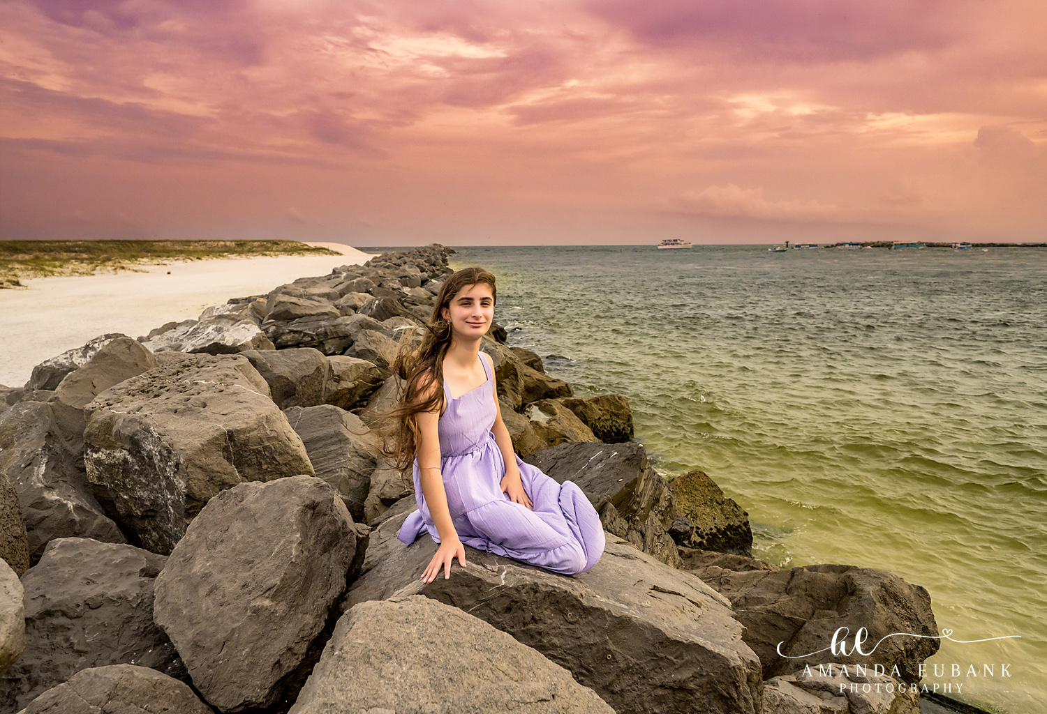 Destin Jetties Family Photos | Girl in a lavender dress A girl in a lavender dress on the rocks at the Destin Jetties in Destin, Florida at sunset, photographed by Destin family photographer Amanda Eubank