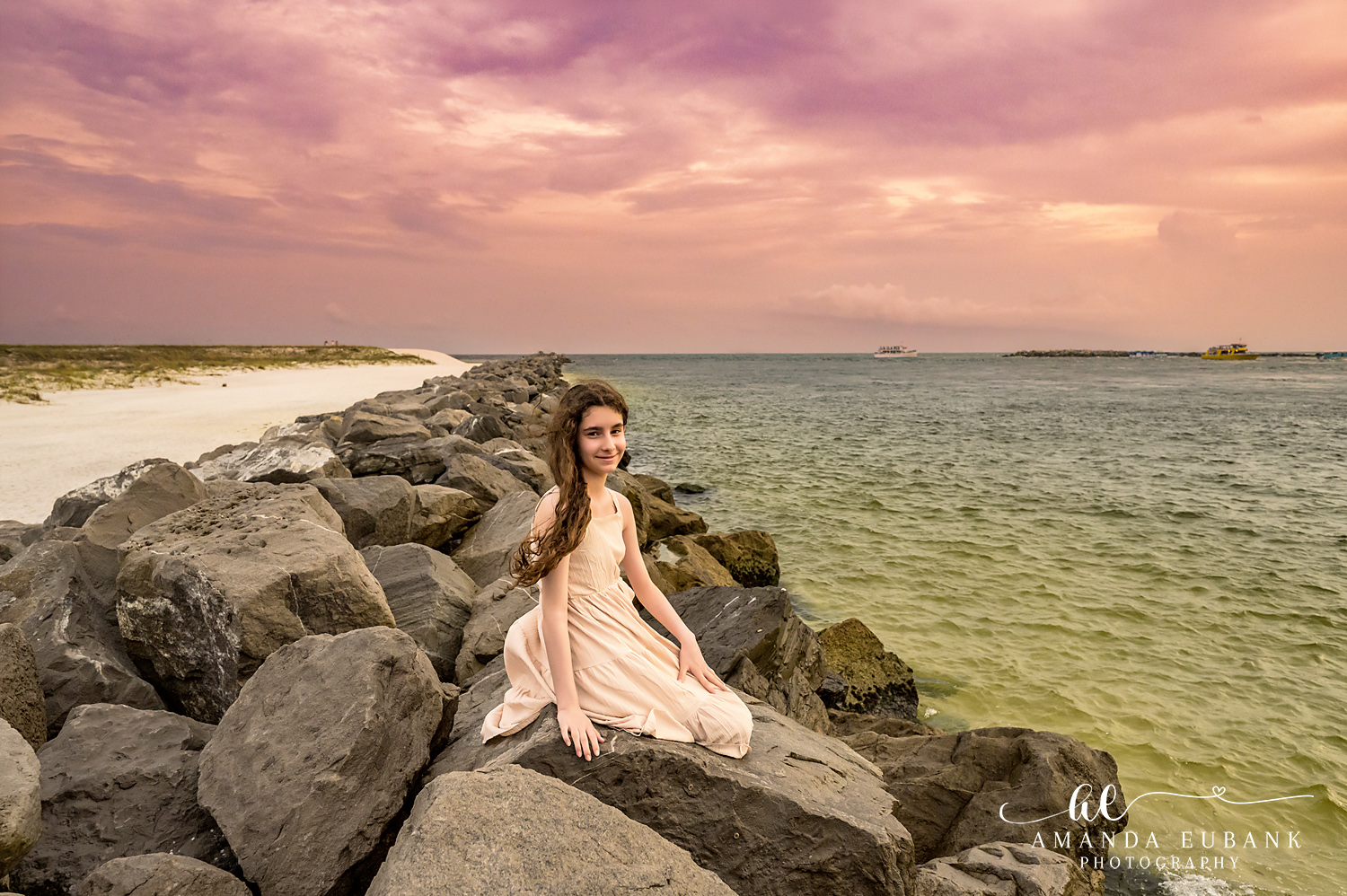 Destin Jetties Family Photos | Girl in a blush dress A girl in a blush dress on the rocks at the Destin Jetties in Destin, Florida at sunset, photographed by Destin family photographer Amanda Eubank