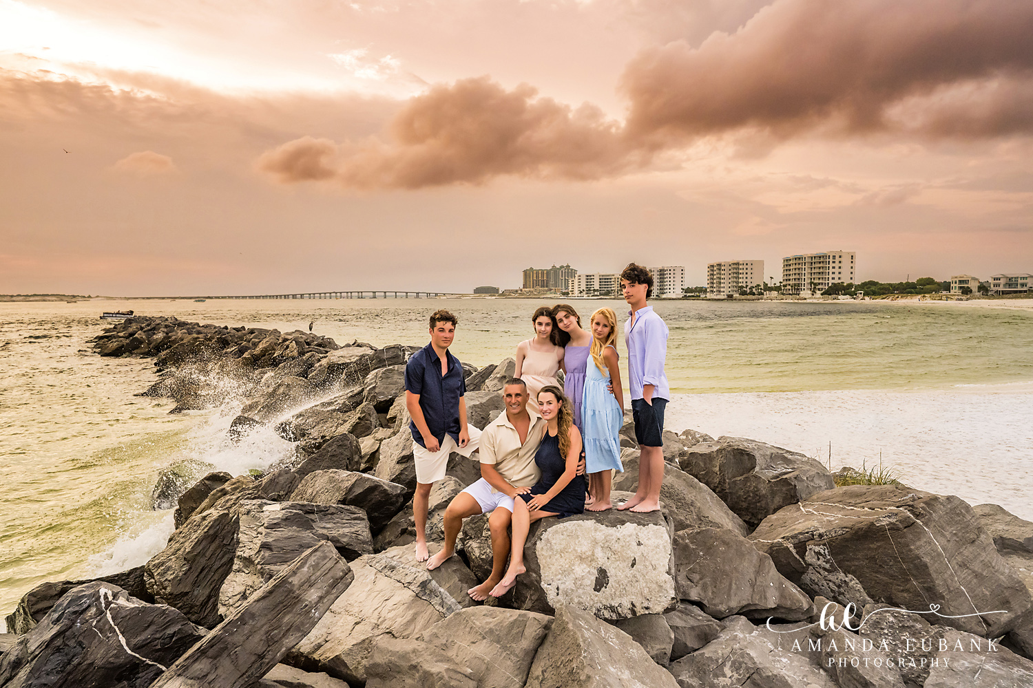 Destin Jetties Family Photos | Kids posing together Kids posing together on the rocks at the Destin Jetties in Destin, Florida at sunset, photographed by Destin family photographer Amanda Eubank