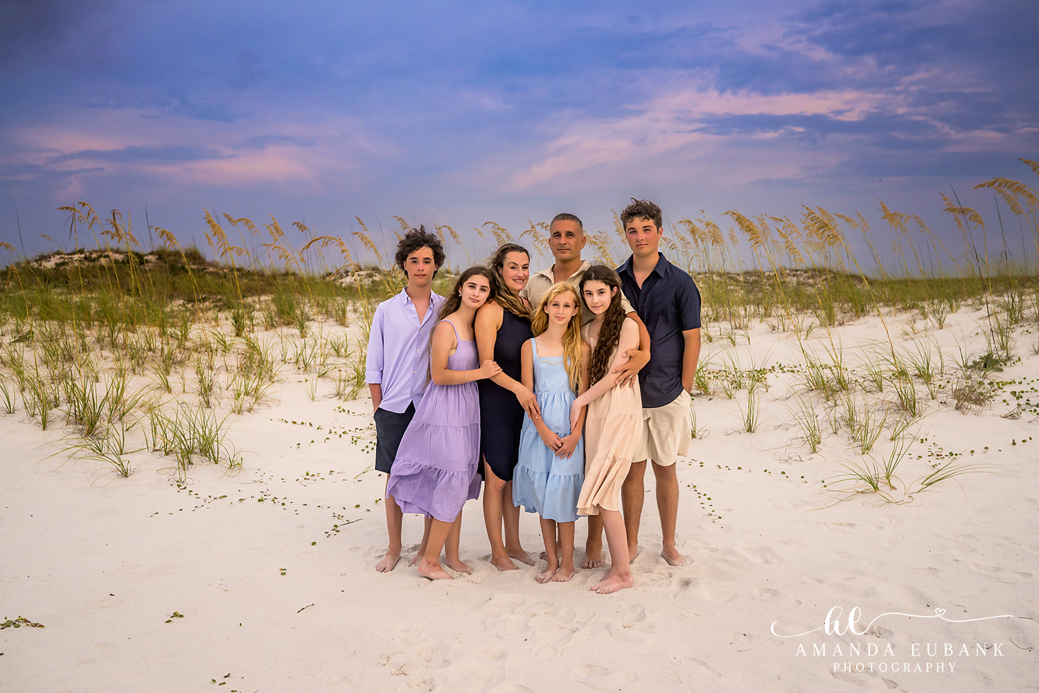 Destin Jetties Family Photos | Large family group portrait A large family group portrait among the sea oats and dunes near the Destin Jetties in Destin, Florida at sunset, photographed by Destin family photographer Amanda Eubank