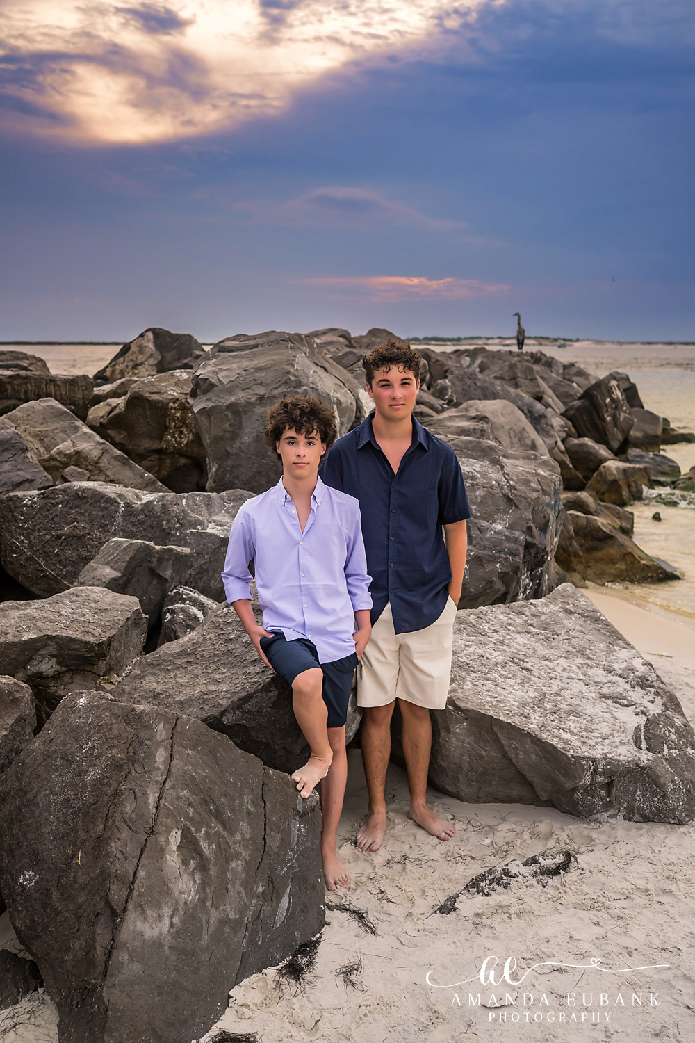 Destin Jetties Family Photos | Two boys standing together Two boys standing together on the rocks at the Destin Jetties in Destin, Florida at sunset, photographed by Destin family photographer Amanda Eubank