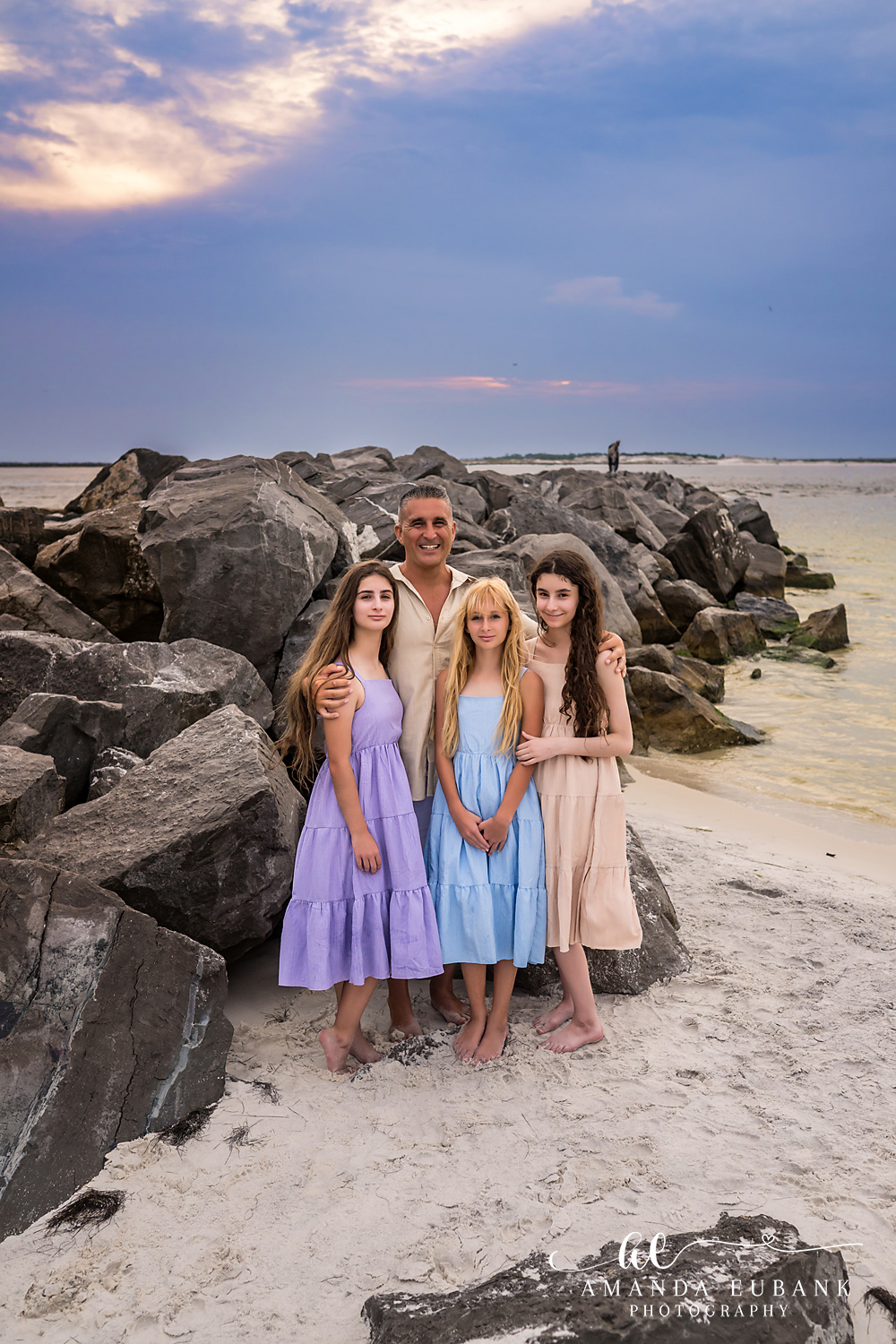 Destin Jetties Family Photos | Four girls standing together Four girls standing together on the rocks at the Destin Jetties in Destin, Florida at sunset, photographed by Destin family photographer Amanda Eubank