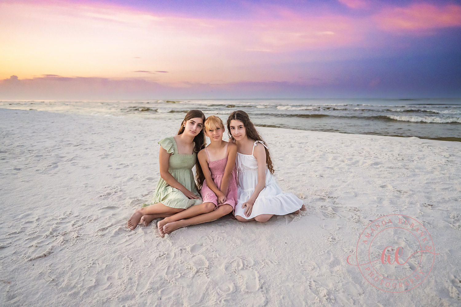Miramar Beach Sunrise Family Photos | Three girls sitting in the sand Three girls sitting in the sand on the beach in Miramar Beach, Florida at sunrise, photographed by Miramar Beach family photographer Amanda Eubank