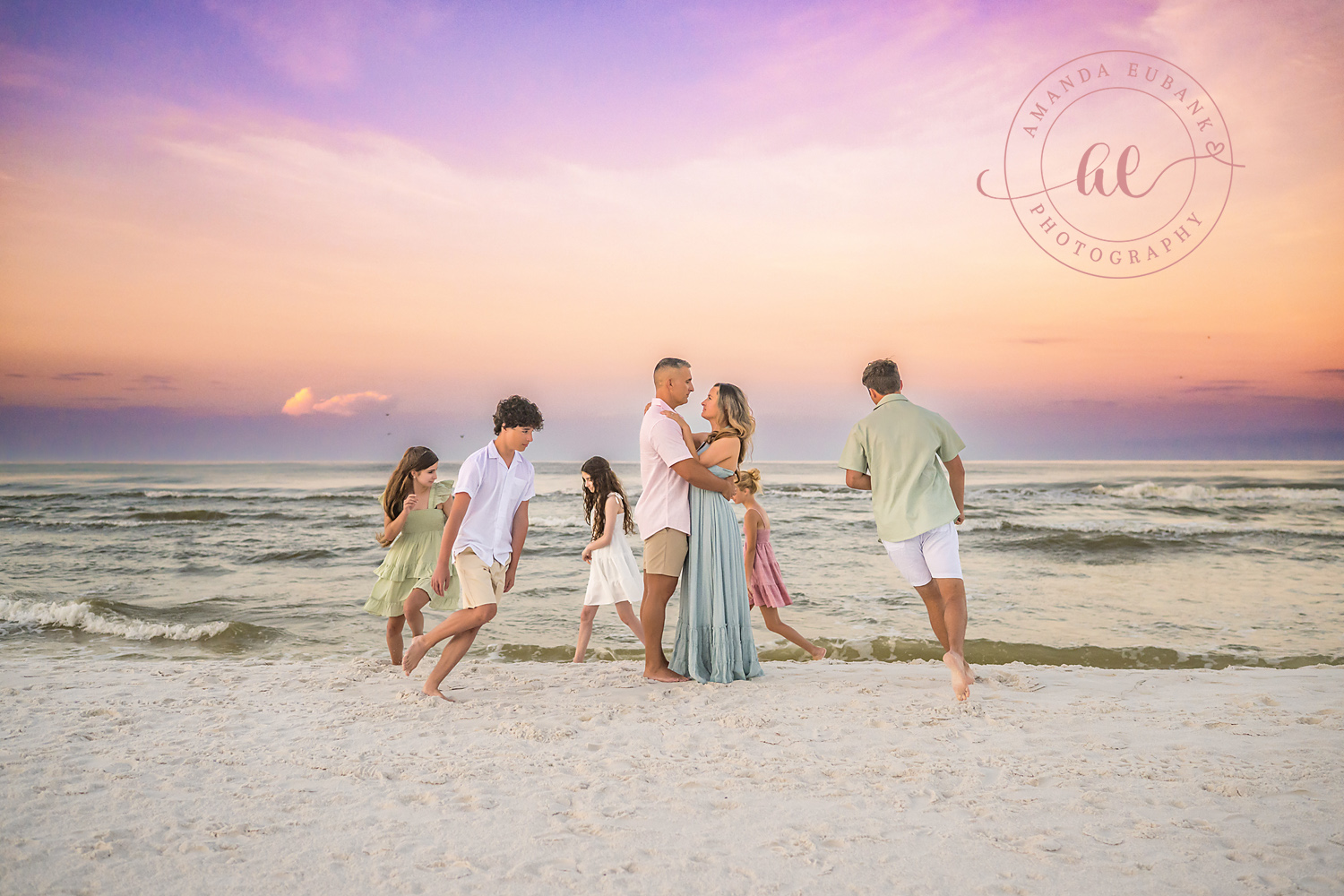 Miramar Beach Sunrise Family Photos | Family laughing at the water’s edge A family laughing at the water's edge on the beach in Miramar Beach, Florida at sunrise, photographed by Miramar Beach family photographer Amanda Eubank