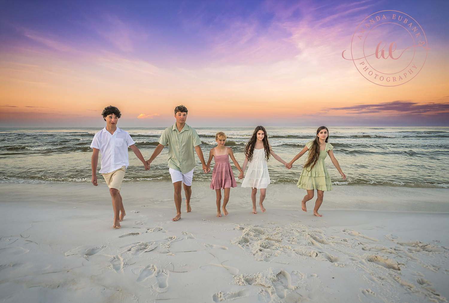 Miramar Beach Sunrise Family Photos | Siblings walking hand in hand Siblings walking hand in hand on the beach in Miramar Beach, Florida at sunrise, photographed by Miramar Beach family photographer Amanda Eubank