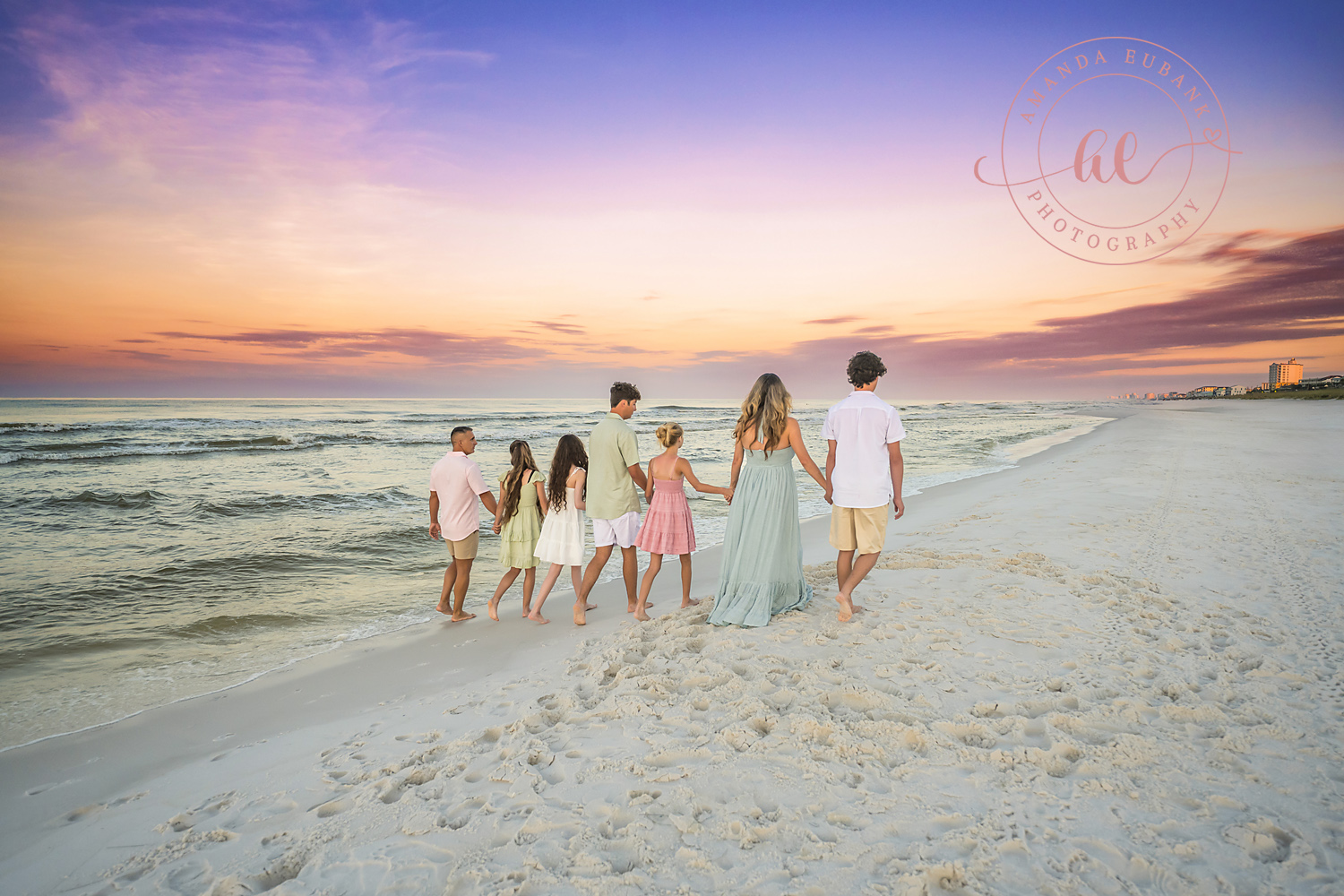 Miramar Beach Sunrise Family Photos | Family walking toward the water A family walking toward the water on the beach in Miramar Beach, Florida at sunrise, photographed by Miramar Beach family photographer Amanda Eubank