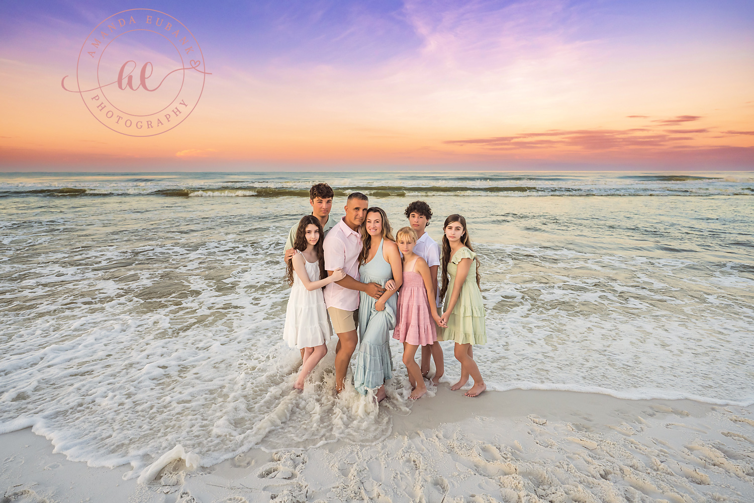 Miramar Beach Sunrise Family Photos | Family group hug in the surf A family group hug in the surf on the beach in Miramar Beach, Florida at sunrise, photographed by Miramar Beach family photographer Amanda Eubank