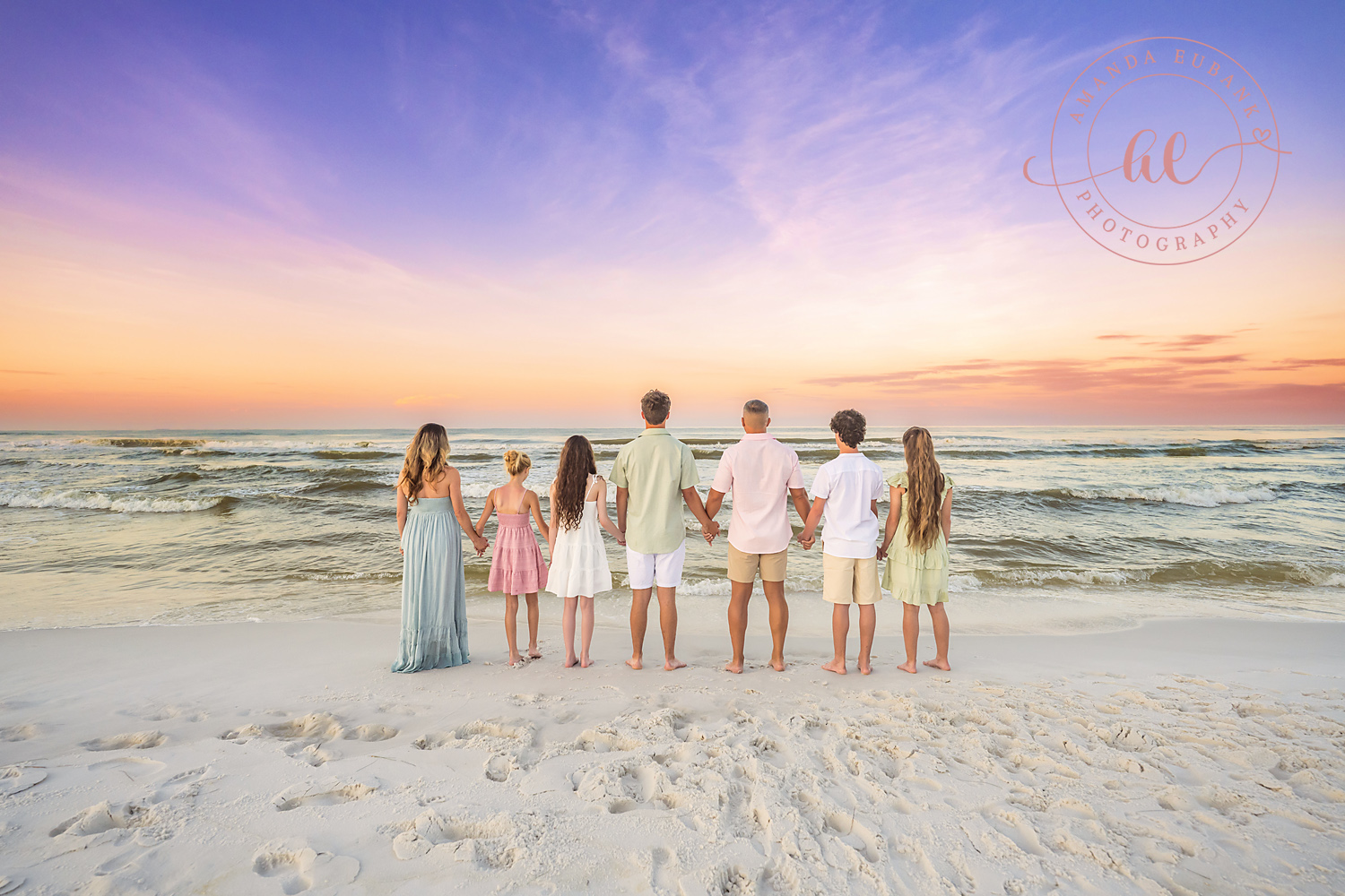 Miramar Beach Sunrise Family Photos | Family looking out at the Gulf A family looking out at the Gulf on the beach in Miramar Beach, Florida at sunrise, photographed by Miramar Beach family photographer Amanda Eubank