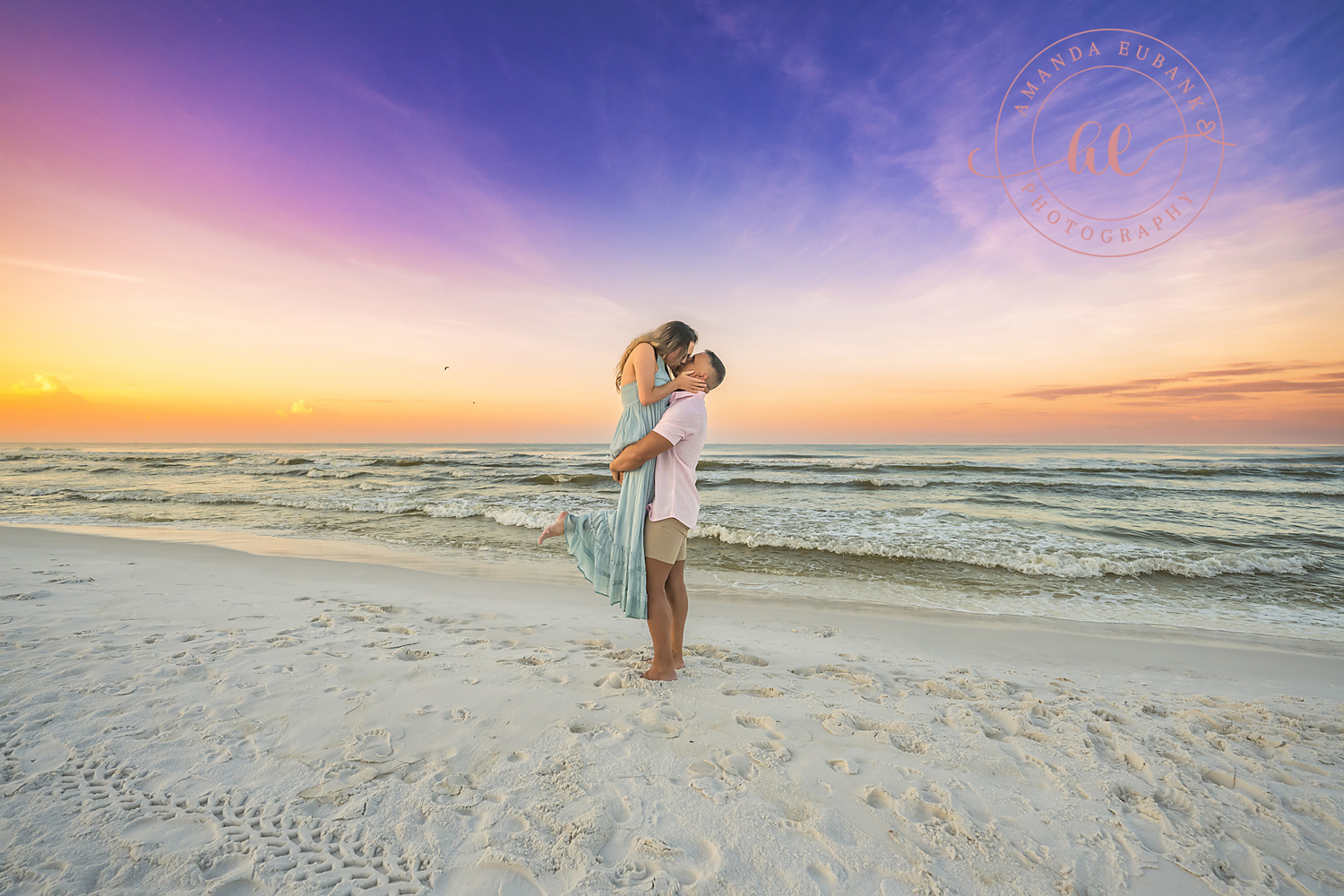 Miramar Beach Sunrise Family Photos | Couple sharing a kiss at the shoreline A couple sharing a kiss at the shoreline on the beach in Miramar Beach, Florida at sunrise, photographed by Miramar Beach family photographer Amanda Eubank