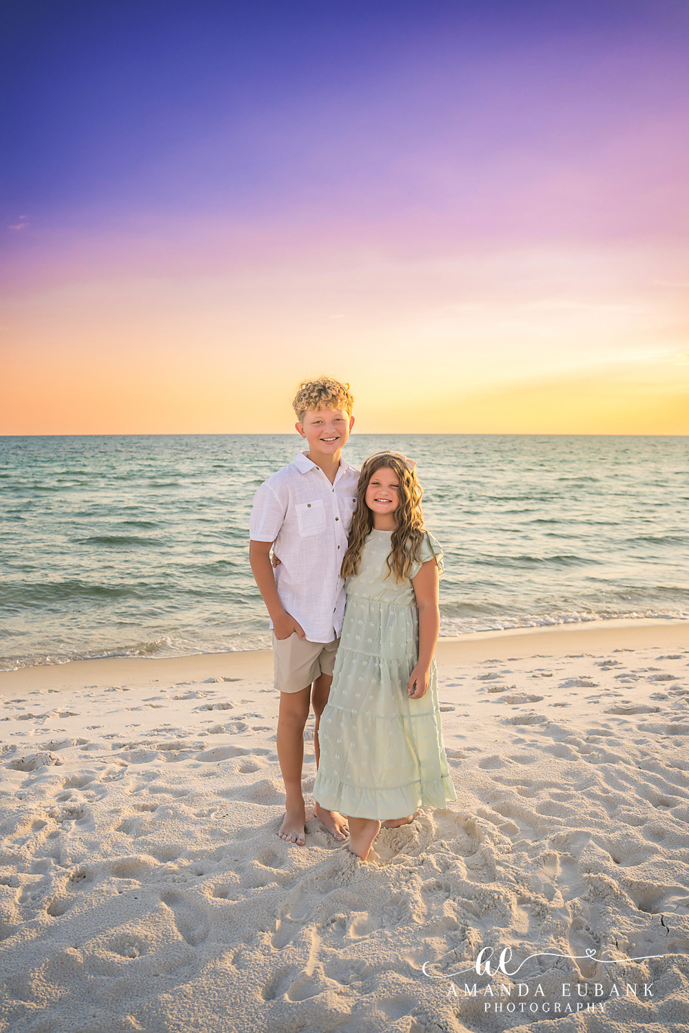 Rosemary Beach Family Photos | Brother and sister standing together A brother and sister standing together on the beach in Rosemary Beach, Florida at sunset, photographed by Rosemary Beach family photographer Amanda Eubank