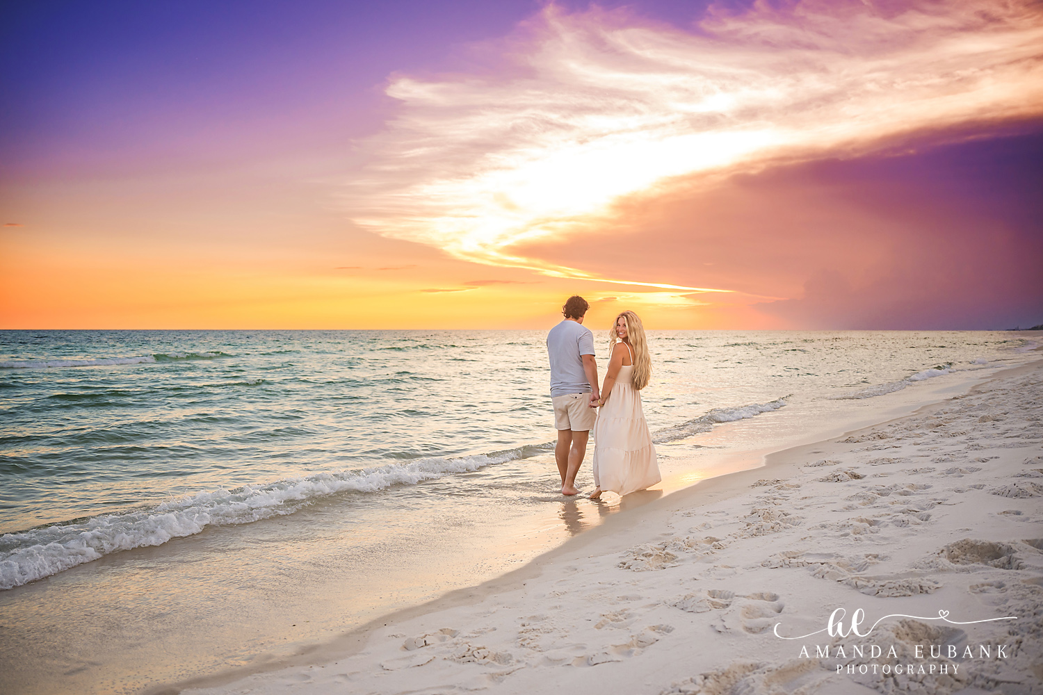 Rosemary Beach Family Photos | Couple walking the shoreline under a dramatic sky A couple walking the shoreline under a dramatic sky on the beach in Rosemary Beach, Florida at sunset, photographed by Rosemary Beach family photographer Amanda Eubank