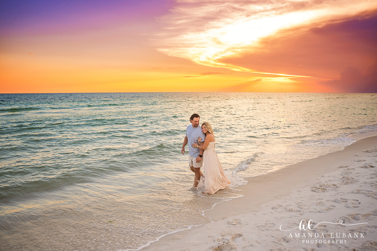 Rosemary Beach Family Photos | Couple embracing on the shoreline A couple embracing on the shoreline on the beach in Rosemary Beach, Florida at sunset, photographed by Rosemary Beach family photographer Amanda Eubank