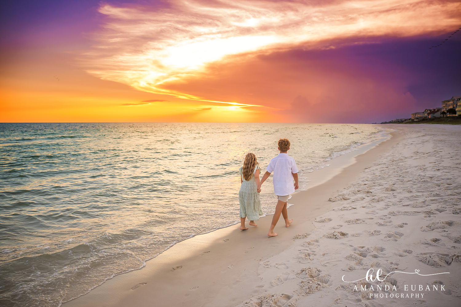 Rosemary Beach Family Photos | Brother and sister walking toward the sunset A brother and sister walking toward the sunset on the beach in Rosemary Beach, Florida at sunset, photographed by Rosemary Beach family photographer Amanda Eubank