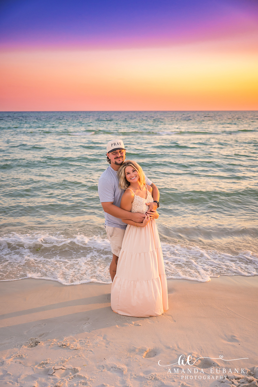 Rosemary Beach Family Photos | Couple embracing in the surf A couple embracing in the surf on the beach in Rosemary Beach, Florida at sunset, photographed by Rosemary Beach family photographer Amanda Eubank