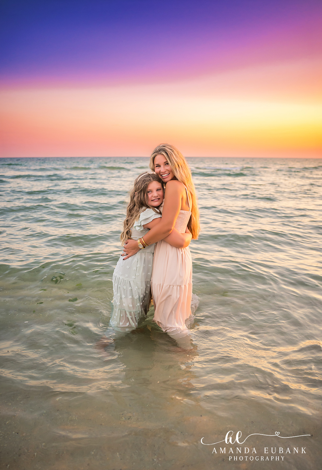 Rosemary Beach Family Photos | Mom and daughter hugging in the surf Mom and daughter hugging in the surf on the beach in Rosemary Beach, Florida at sunset, photographed by Rosemary Beach family photographer Amanda Eubank