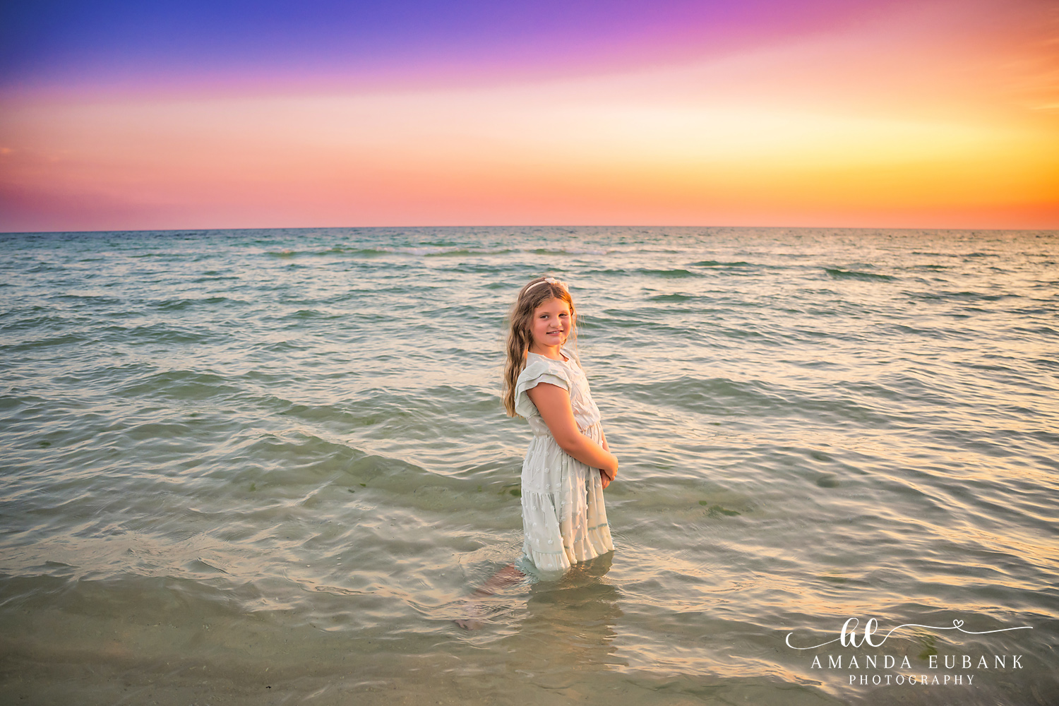 Rosemary Beach Family Photos | Girl standing in the water A girl standing in the water on the beach in Rosemary Beach, Florida at sunset, photographed by Rosemary Beach family photographer Amanda Eubank