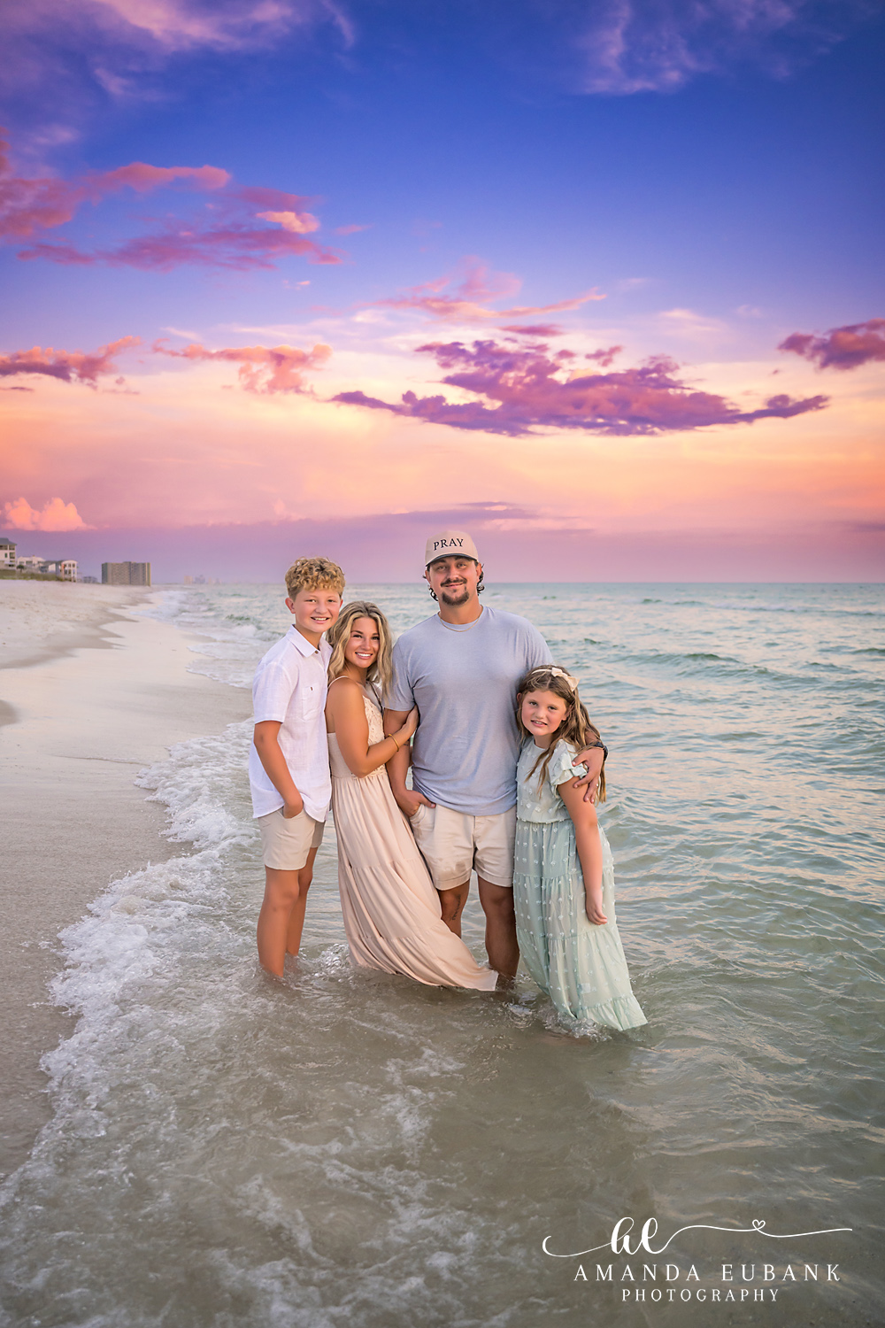 Rosemary Beach Family Photos | Family of four in the surf A family of four in the surf on the beach in Rosemary Beach, Florida at sunset, photographed by Rosemary Beach family photographer Amanda Eubank