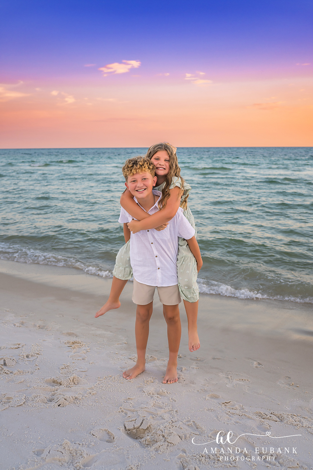 Rosemary Beach Family Photos | Brother and sister hugging A brother and sister hugging on the beach in Rosemary Beach, Florida at sunset, photographed by Rosemary Beach family photographer Amanda Eubank