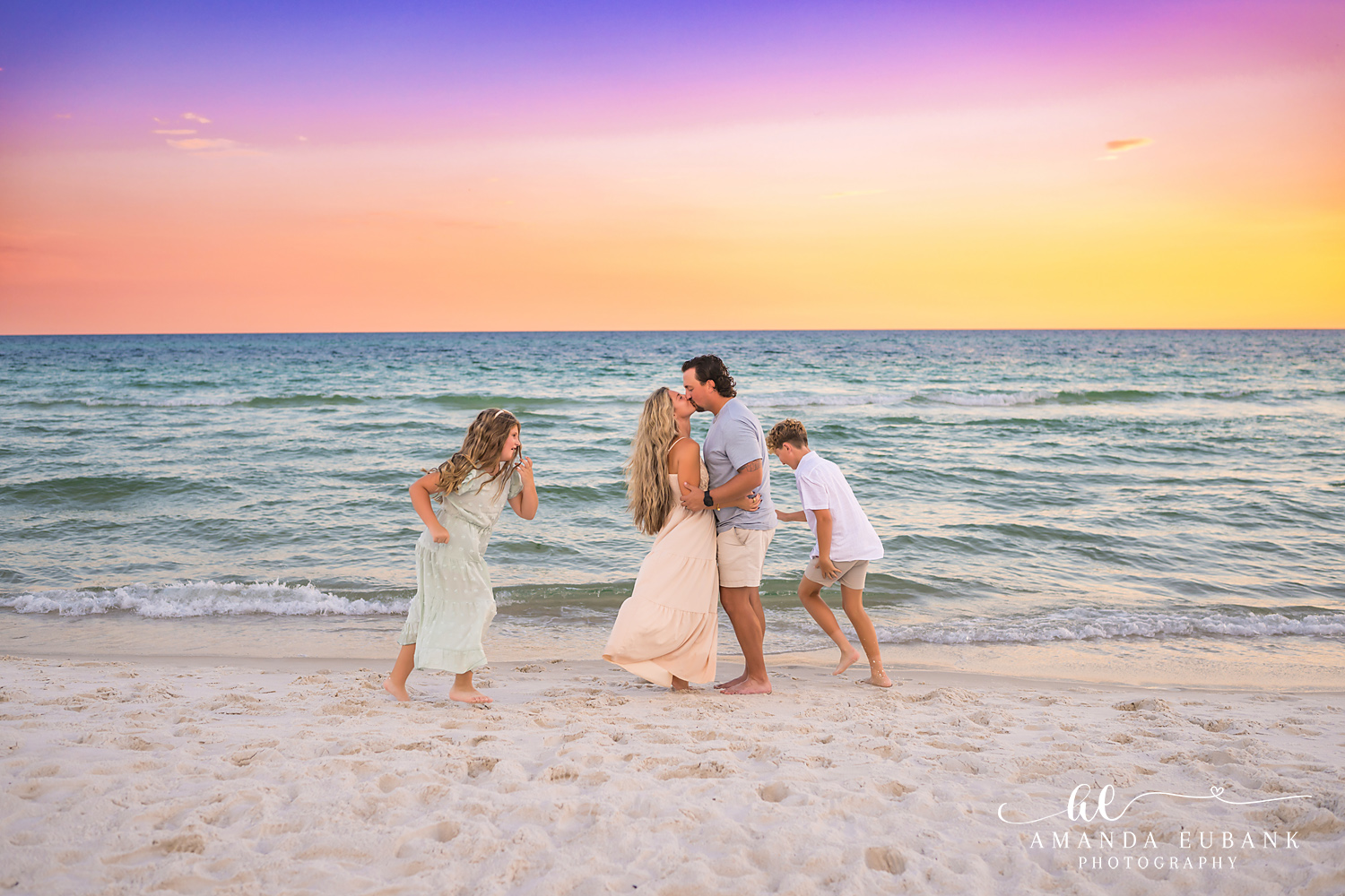 Rosemary Beach Family Photos | Family laughing together A family laughing together on the beach in Rosemary Beach, Florida at sunset, photographed by Rosemary Beach family photographer Amanda Eubank