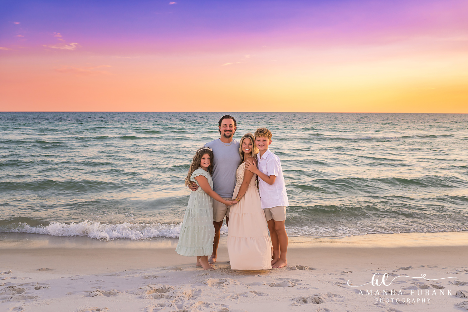 Rosemary Beach Family Photos | Family of four by the water A family of four by the water on the beach in Rosemary Beach, Florida at sunset, photographed by Rosemary Beach family photographer Amanda Eubank