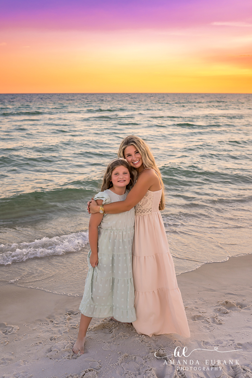 Rosemary Beach Family Photos | Mom and daughter standing together Mom and daughter standing together on the beach in Rosemary Beach, Florida at sunset, photographed by Rosemary Beach family photographer Amanda Eubank