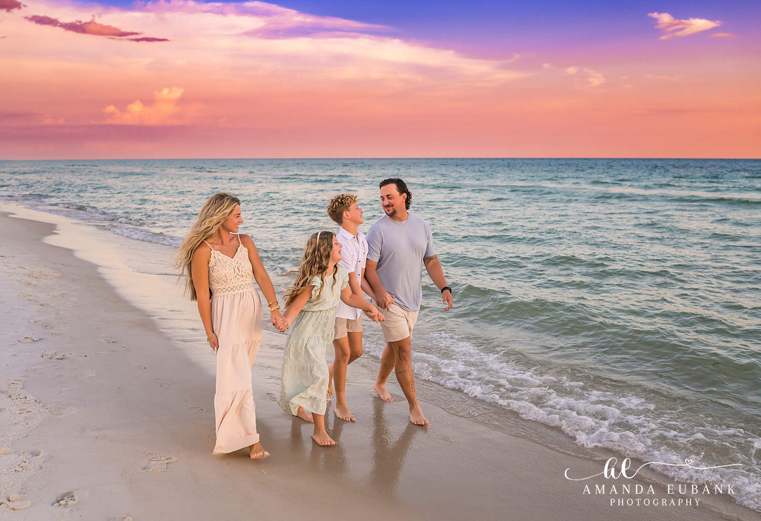 Rosemary Beach Family Photos | Family walking the shoreline A family walking the shoreline on the beach in Rosemary Beach, Florida at sunset, photographed by Rosemary Beach family photographer Amanda Eubank