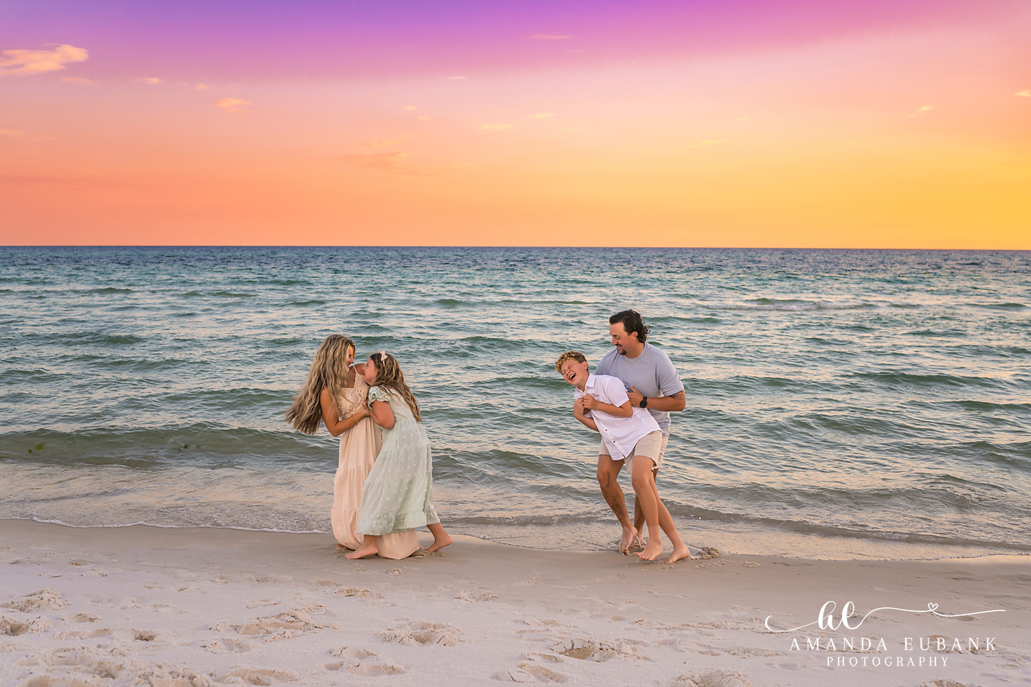Rosemary Beach Family Photos | Playful family moment on the shoreline A playful family moment on the shoreline on the beach in Rosemary Beach, Florida at sunset, photographed by Rosemary Beach family photographer Amanda Eubank